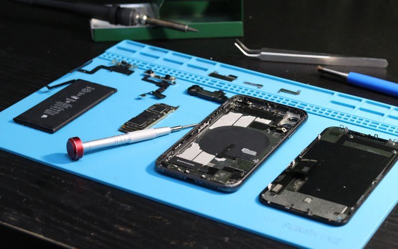 Electronics repair shop with technician servicing devices