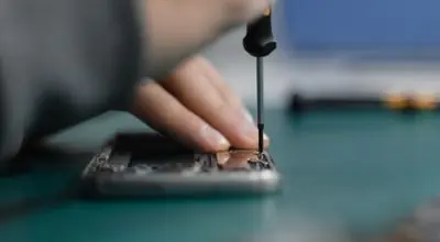 Electronics repair technician fixing phone
