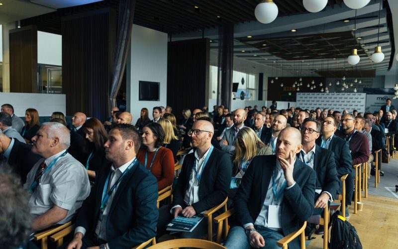 Corporate event venue with conference setup and audience