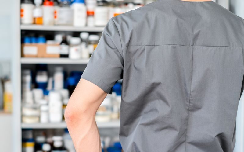 Vendra pharmacy management software — pharmacist at dispensing counter
