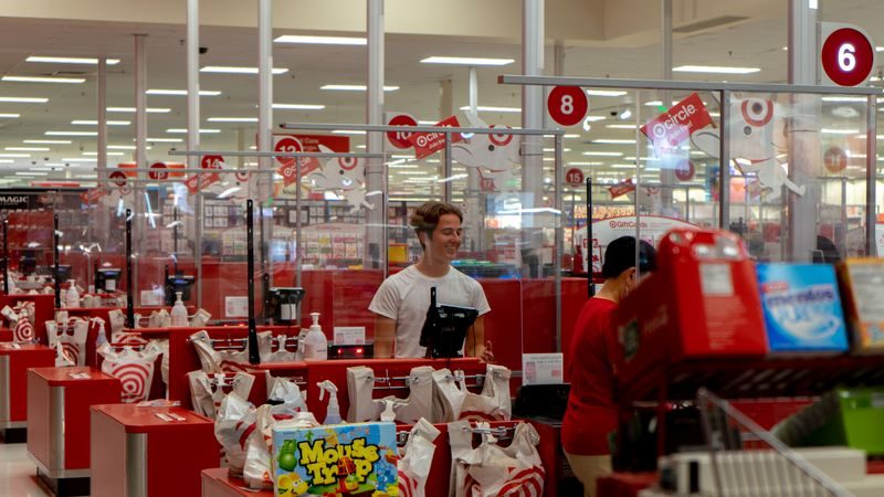 Supermarket checkout counter with customers in queue