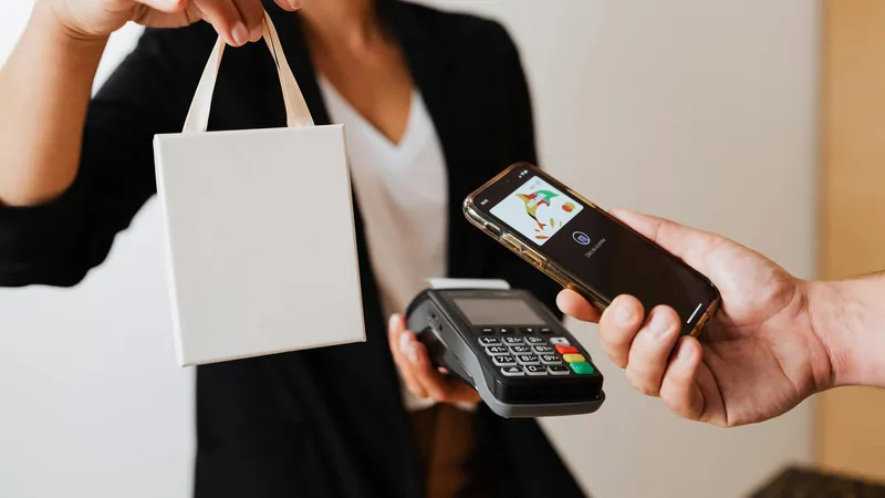 Mobile payment integration for business — customer tapping phone on payment terminal