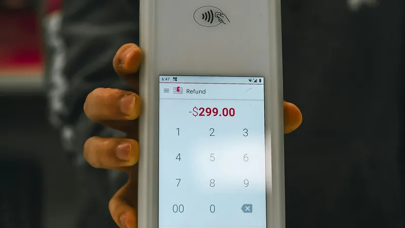 Best POS system — cashier using a payment terminal at retail checkout